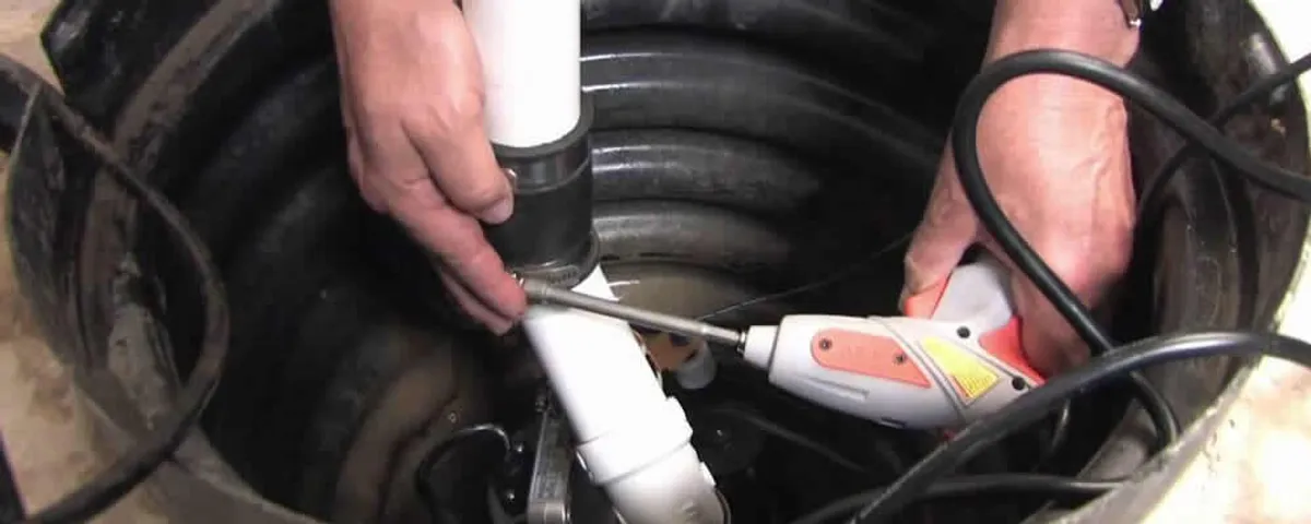 Sump pump installation technician connecting PVC discharge piping in Brandon, FL